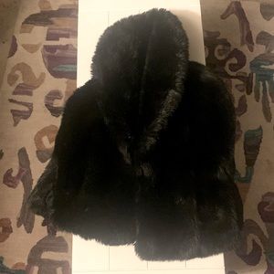 faux fur black over the shoulder shawl jacket Hook front closure and has pockets